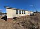 Mobile home with damaged siding, viewed from the side at 169 Adams Cir, Candor, NC 27229