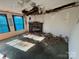 Living room with damaged ceiling and carpet. Features a stone fireplace at 169 Adams Cir, Candor, NC 27229