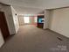 Open living and dining area with carpet flooring at 169 Adams Cir, Candor, NC 27229