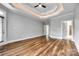 Large bedroom with hardwood floors, a tray ceiling, and neutral paint at 1765 Old Clay Hill Rd, York, SC 29745