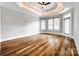 Bright bedroom featuring hardwood floors, ample natural light, and a tray ceiling at 1765 Old Clay Hill Rd, York, SC 29745