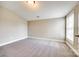 Well-lit bedroom with neutral walls, carpet, and a large window at 1765 Old Clay Hill Rd, York, SC 29745