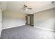 Neutral bedroom with carpet, ceiling fan and open doorway at 1765 Old Clay Hill Rd, York, SC 29745