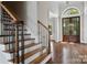 Elegant entryway features hardwood floors, staircase with iron spindles, and a double door with arched window at 1765 Old Clay Hill Rd, York, SC 29745