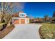 Attached two-car garage with brick facade and long concrete driveway at 1765 Old Clay Hill Rd, York, SC 29745