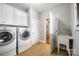 Well-equipped laundry room with white cabinetry, a utility sink, and modern washer and dryer at 1765 Old Clay Hill Rd, York, SC 29745