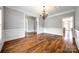 Spacious living room featuring hardwood floors, elegant wainscoting, and open doorways for seamless flow at 1765 Old Clay Hill Rd, York, SC 29745