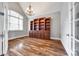 Spacious home office featuring hardwood floors, built-in bookshelves, and a chandelier at 1765 Old Clay Hill Rd, York, SC 29745