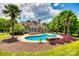 Resort style pool and patio area complete with lounge chairs and tropical landscaping in backyard of home at 1765 Old Clay Hill Rd, York, SC 29745