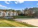 Exterior view of lakefront condos with a pool and sandy beach at 17811 Half Moon Ln # E, Cornelius, NC 28031