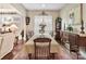 Dining room featuring hardwood floors, neutral walls, and natural light from a large window at 2001 Arbor Hills Dr, Indian Trail, NC 28079