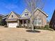 Charming brick home with a manicured front yard and a two-car garage beneath a clear blue sky at 2001 Arbor Hills Dr, Indian Trail, NC 28079