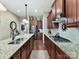 A spacious kitchen featuring granite countertops, stainless steel appliances, and dark wood cabinets at 2001 Arbor Hills Dr, Indian Trail, NC 28079