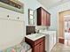 Laundry room has a utility sink with bench and upper wood cabinets at 2001 Arbor Hills Dr, Indian Trail, NC 28079