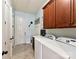 Bright laundry room boasts upper wood cabinets and a utility sink at 2001 Arbor Hills Dr, Indian Trail, NC 28079