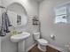 Small bathroom with pedestal sink and toilet at 215 Briana Marie Way, Indian Trail, NC 28079