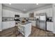 Modern kitchen with white cabinets, granite countertops, and stainless steel appliances at 215 Briana Marie Way, Indian Trail, NC 28079