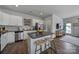 Modern kitchen with white cabinets, granite countertops, and stainless steel appliances at 215 Briana Marie Way, Indian Trail, NC 28079