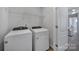 Convenient laundry room with washer, dryer, and overhead shelving at 215 Briana Marie Way, Indian Trail, NC 28079