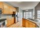 Bright kitchen with stainless steel refrigerator and granite island with a large stainless sink at 2288 S Paraham Rd, York, SC 29745