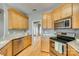 Well-lit kitchen featuring stainless steel appliances, granite countertops and hardwood flooring at 2288 S Paraham Rd, York, SC 29745