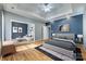 Stylish main bedroom features a sitting area, tray ceiling and modern ceiling fan at 2288 S Paraham Rd, York, SC 29745