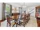 Formal dining room featuring a large wooden table, chandelier, and elegant decor at 2315 Red Fox Trl, Charlotte, NC 28211