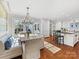 Open-concept dining area with modern chandelier and bench seating, adjacent to the kitchen at 2315 Red Fox Trl, Charlotte, NC 28211