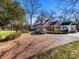 Exterior of home with brick driveway and well-maintained landscaping in a sunny location at 2315 Red Fox Trl, Charlotte, NC 28211