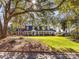 Brick home featuring mature shade trees and a lush lawn, offering privacy and curb appeal at 2315 Red Fox Trl, Charlotte, NC 28211