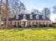 Charming brick home with black shutters, dormer windows, and a manicured lawn at 2315 Red Fox Trl, Charlotte, NC 28211