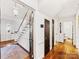 Bright foyer with hardwood floors, a staircase, and elegant lighting fixtures at 2315 Red Fox Trl, Charlotte, NC 28211