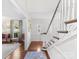 Inviting foyer with hardwood floors, a staircase, and natural light, creating a warm ambiance at 2315 Red Fox Trl, Charlotte, NC 28211