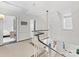 Bright hallway featuring a staircase with a unique railing and neutral colored patterned carpet at 2315 Red Fox Trl, Charlotte, NC 28211