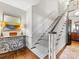 Hallway leading to carpeted stairs with wooden floors and a painted artwork on the wall at 2315 Red Fox Trl, Charlotte, NC 28211