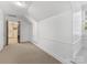 Bright hallway with neutral tones, carpeted floors, and a visible staircase at 2315 Red Fox Trl, Charlotte, NC 28211