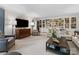 Bright living room with built-in bookshelves, a large TV, and comfortable furnishings at 2315 Red Fox Trl, Charlotte, NC 28211