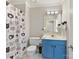 Bathroom with blue vanity, shower, and cat-themed shower curtain at 2410 Hopecrest Dr, Charlotte, NC 28210