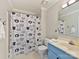 Cute bathroom with a light blue vanity and cat-themed shower curtain at 2410 Hopecrest Dr, Charlotte, NC 28210