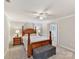 Basement bedroom with wooden bed frame and ceiling fan at 2410 Hopecrest Dr, Charlotte, NC 28210