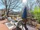 Deck with seating area and umbrella, overlooking a scenic backyard at 2410 Hopecrest Dr, Charlotte, NC 28210