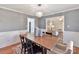 Bright dining room with wood table and view into the living room at 2410 Hopecrest Dr, Charlotte, NC 28210