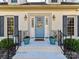 Brick home with gray shutters, a light blue door, and landscaping at 2410 Hopecrest Dr, Charlotte, NC 28210