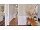 Hardwood floor hallway with white wainscoting and console table at 2410 Hopecrest Dr, Charlotte, NC 28210