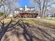 Back of house showcasing a large deck and backyard at 2410 Hopecrest Dr, Charlotte, NC 28210