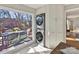 Stackable washer and dryer in laundry room with deck view at 2410 Hopecrest Dr, Charlotte, NC 28210