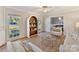 Living room with built-in shelving, large windows, and seating area at 2410 Hopecrest Dr, Charlotte, NC 28210