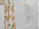 Clean white tub and shower combo with a showerhead and green leaf pattern curtain at 2943 Village Center Dr, Dallas, NC 28034