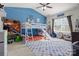 Fun bedroom with blue walls, gaming decor, bunkbeds with a slide, and lots of natural light at 2943 Village Center Dr, Dallas, NC 28034