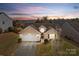 Lovely sunset aerial view of a well maintained home with beautiful landscaping at 2943 Village Center Dr, Dallas, NC 28034